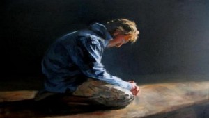 man kneeling in prayer